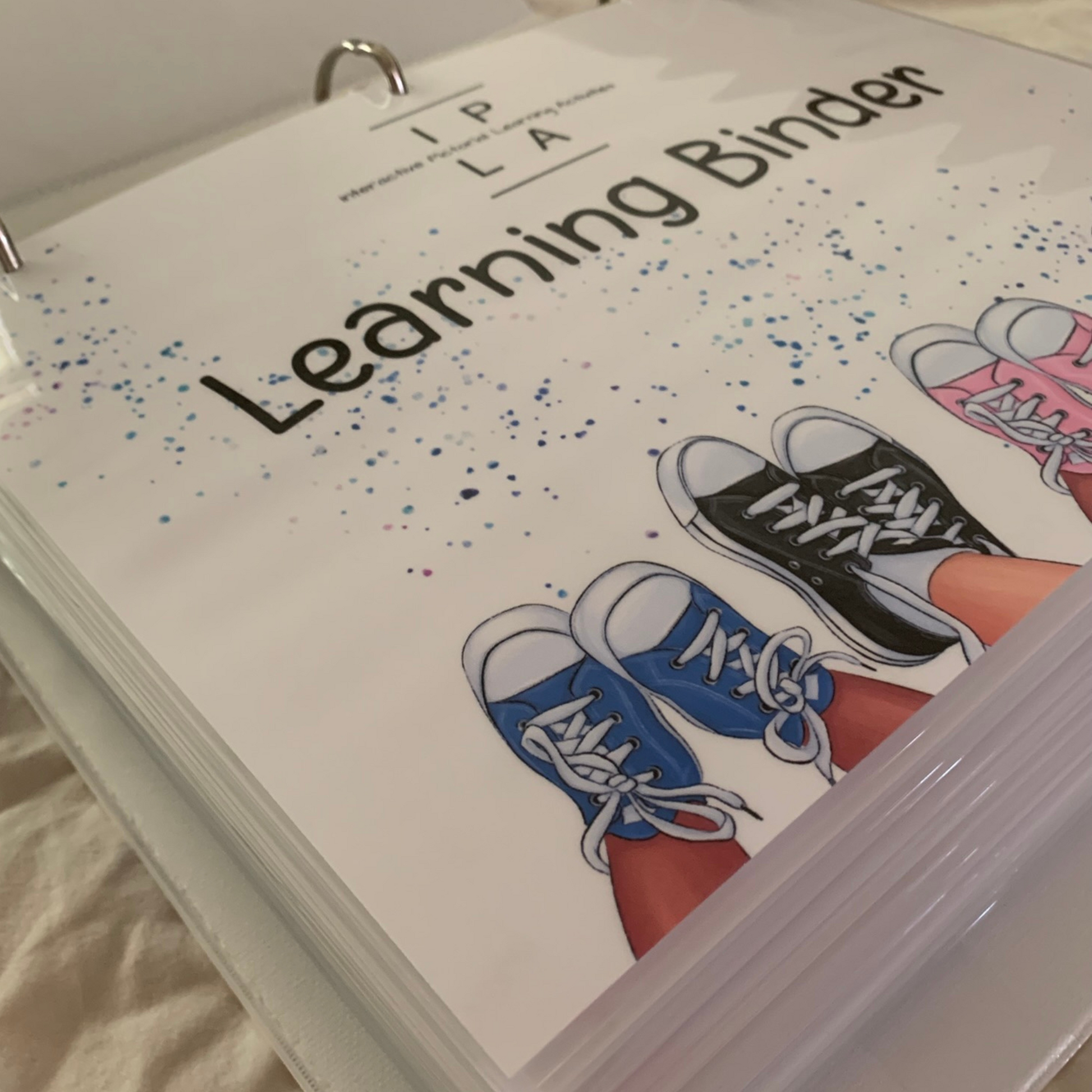 IPLActivites Learning binder cover with logo and picture of shoes 
